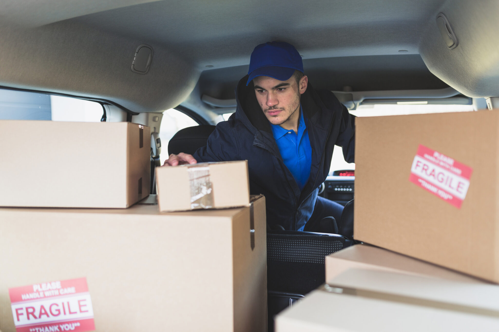 man-car-checking-boxes-delivery